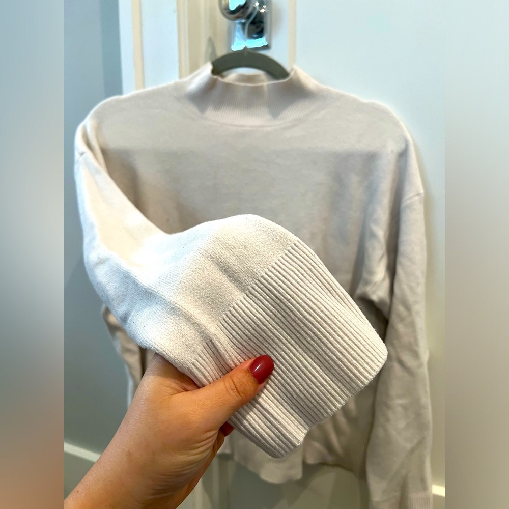 White sweater perfect for windy spring days, fall, or as a winter layer